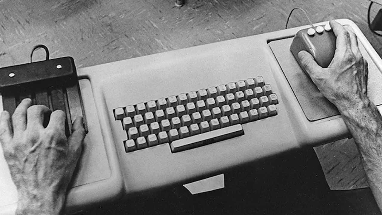 Hands operating a keyboard, chorded keyset, and mouse